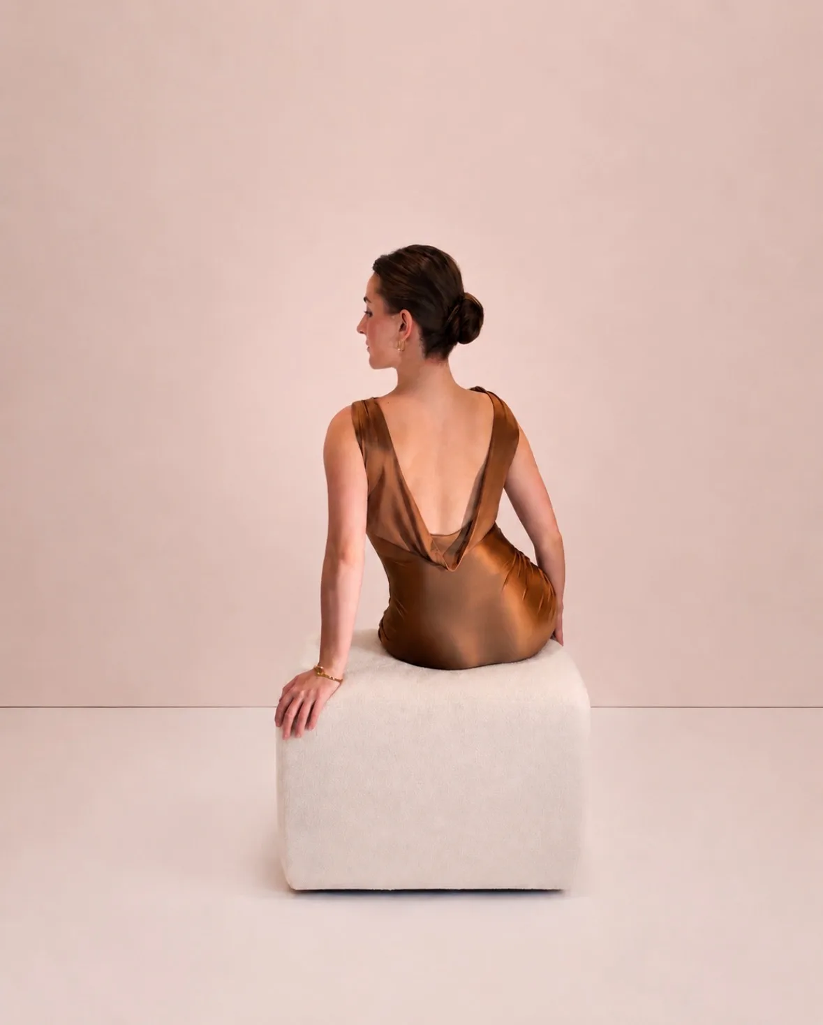 A portrait in a draped dress inspired by a bronze slingback heel.