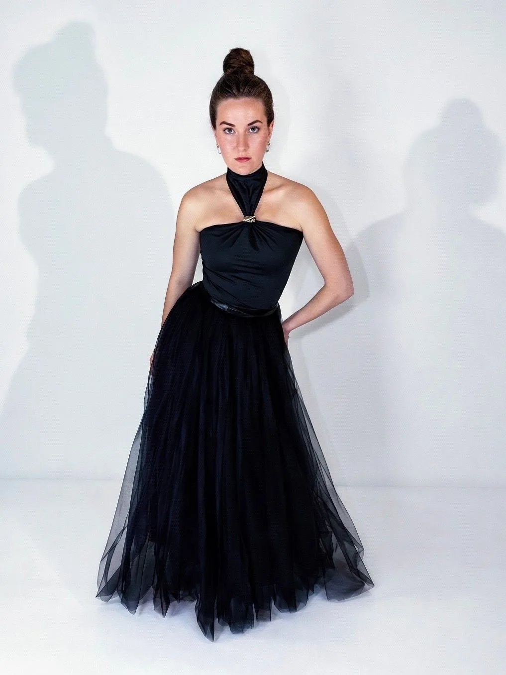Full-length Feather Bag portrait in a black tulle gown.