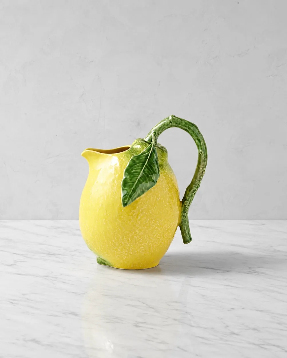 A pale yellow lemonade pitcher.